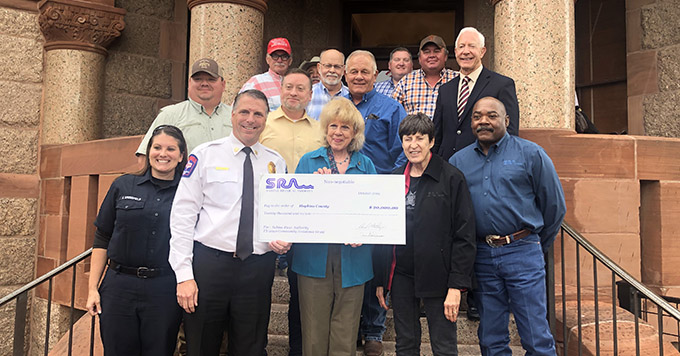 Group of people accepting check from SRA Economic Development